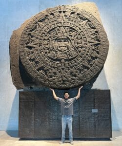 Me holding up a circular Mayan Calandar at the National Museum of Anthropology in Mexico City