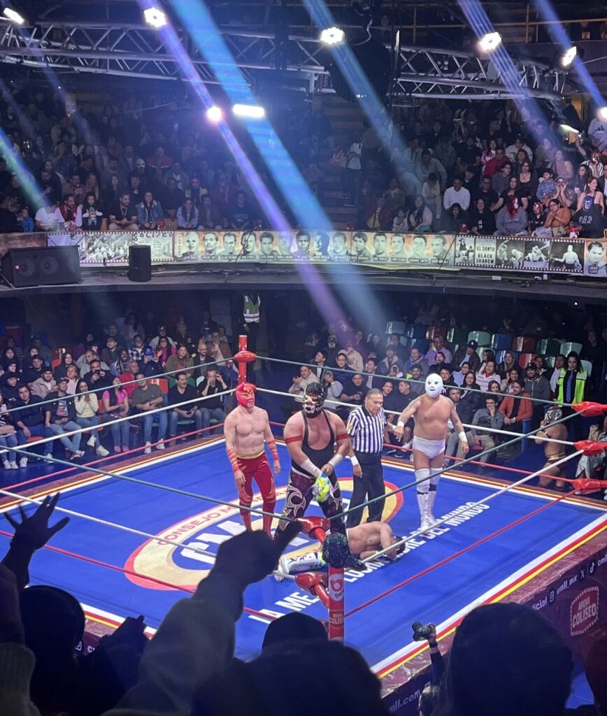 A group of wrestlers in the wrestling ring at Arena Coliseo in Mexico City