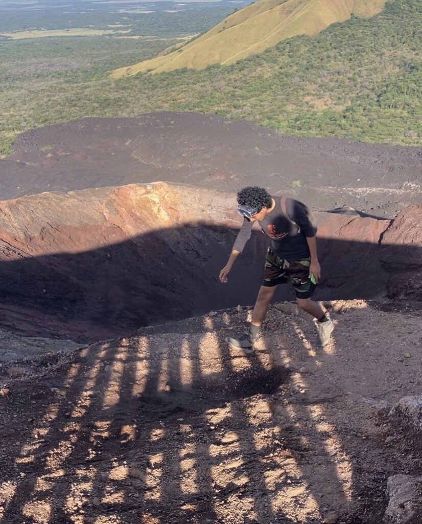 A tour guide showing the heat emitting from Cerro Negro in Nicaragua