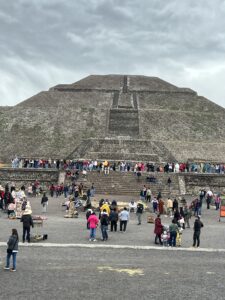 A flock pf people viewing a huge pyramid at Teotihuacán near Mexico City