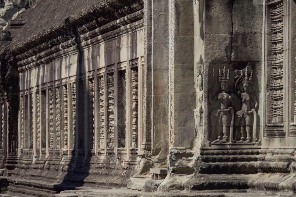 Stone gallery and carved walls inside Angkor Wat in Cambodia