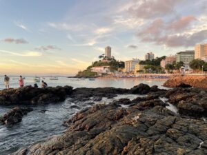 A landscape photo of a beach and rocks in Salvador, Brazil