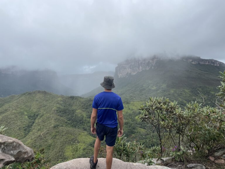 Me with my back turned, looking at cloud covered mountains