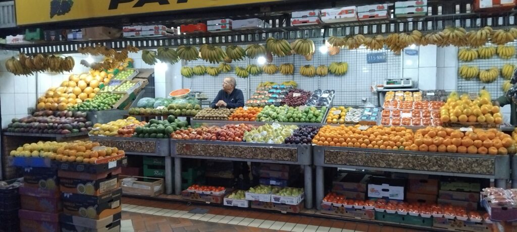 A fruit vendor displaying a large selection of fruit at Mercado Central de Belo Horizonte in Brazil