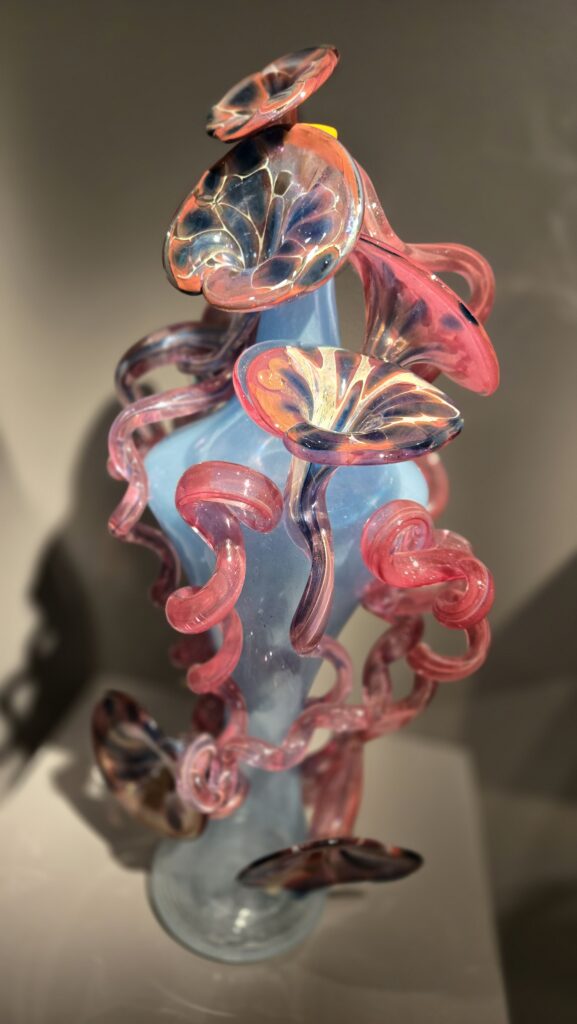An abstract glass artwork of flowers and mushrooms at an exhibit in Meijer Gardens & Sculpture Park in Grand Rapids, Michigan