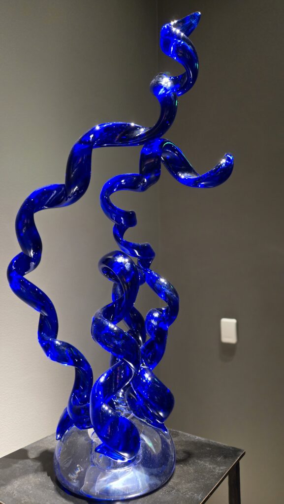 An royal blue glass artwork at an exhibit in Meijer Gardens & Sculpture Park in Grand Rapids, Michigan