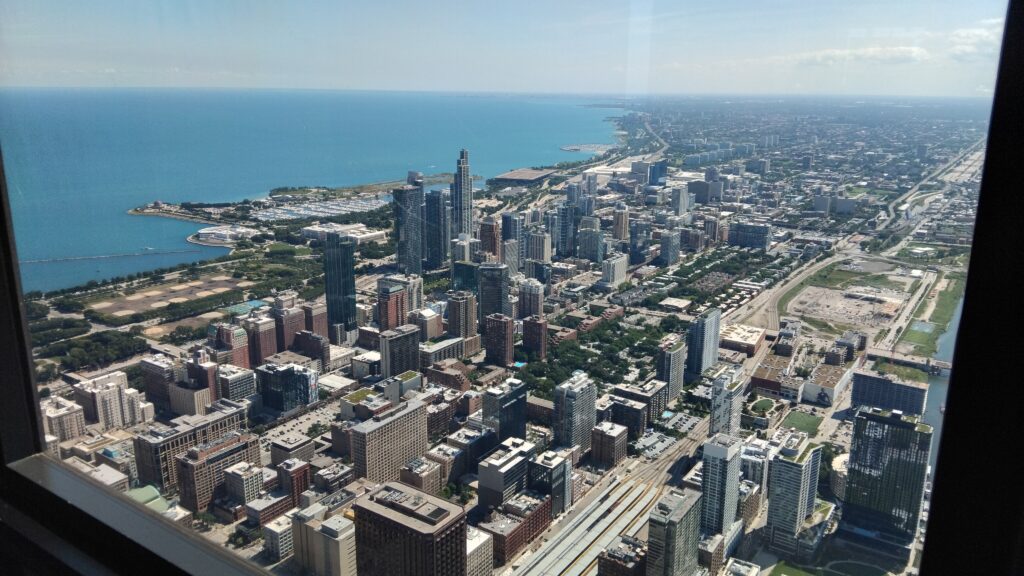 A view of Chicago buildings and Lake Michigan from The Sky Deck of the Willis Tower