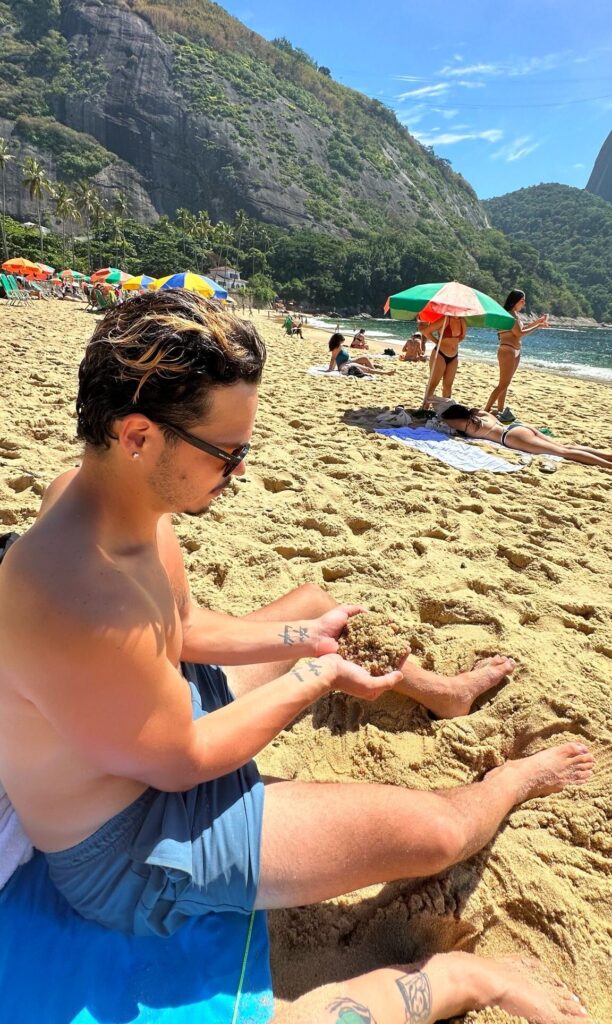 A beautiful sunny day at Praia da Vermelha in Rio de Janeiro, Brazil, sitting in the soft sand