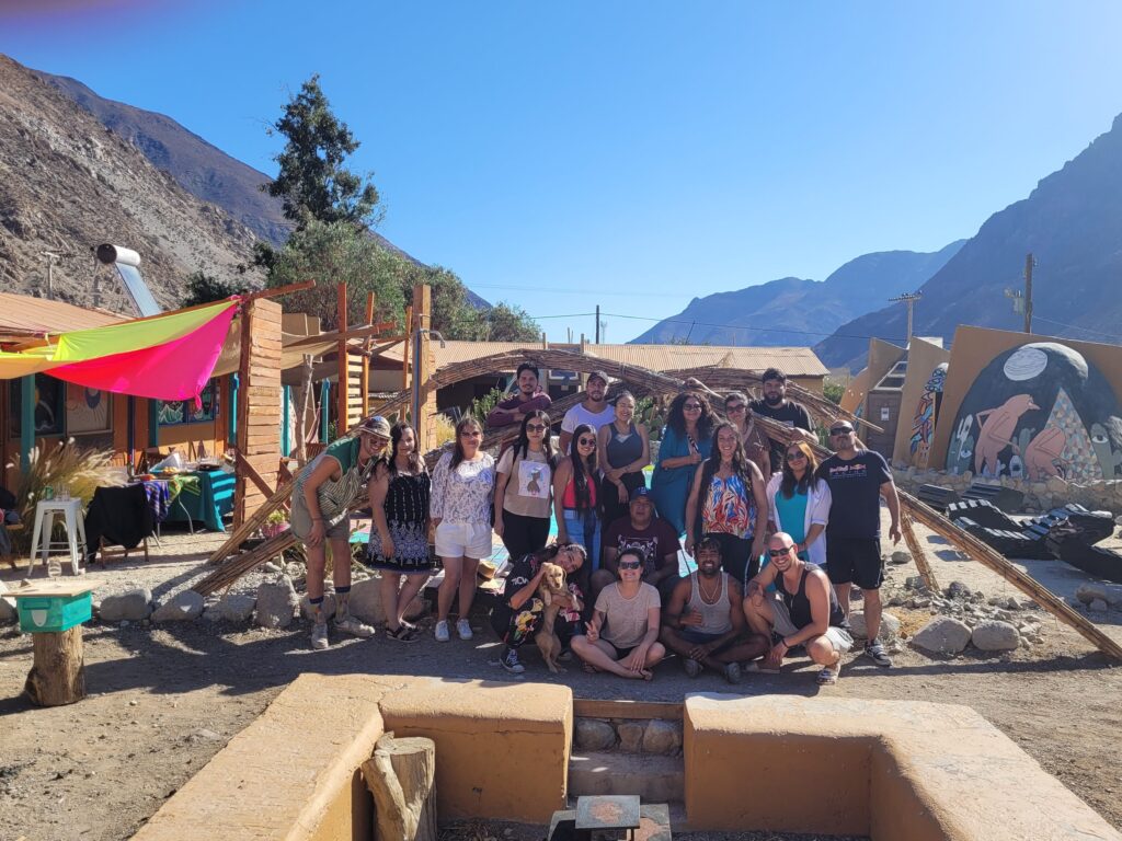 A group photo of guests and volunteers at Cosmo Elqui Hostel in Elqui Valley, Chile