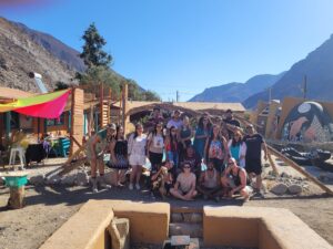 A group photo of guests and volunteers at Cosmo Elqui Hostel in Elqui Valley, Chile