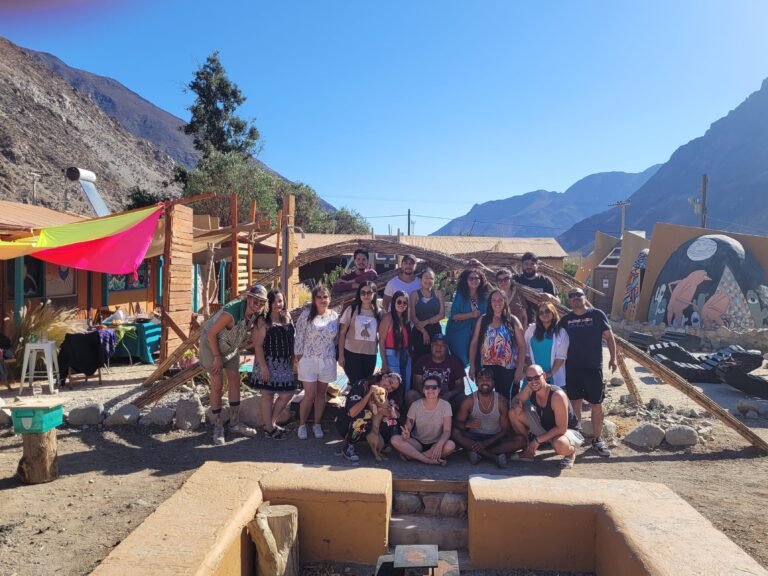 A group photo of guests and volunteers at Cosmo Elqui Hostel in Elqui Valley, Chile