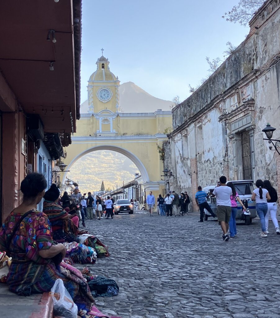 The famous arch and clock on a cobble stone street in Antigua, Guatemala